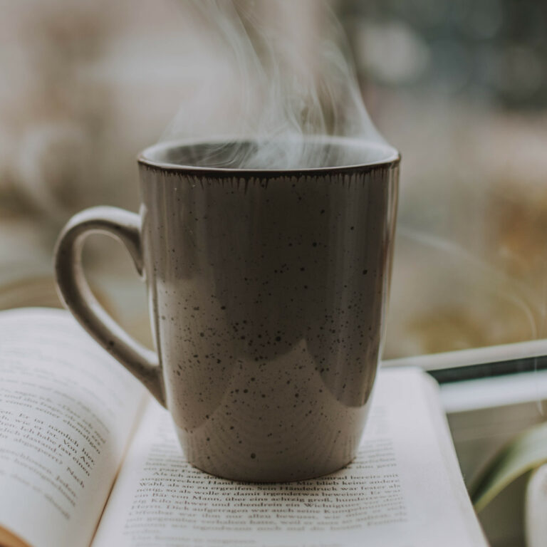 The Waking Up Podcast and Blog (image of a steaming coffee mug on a book)